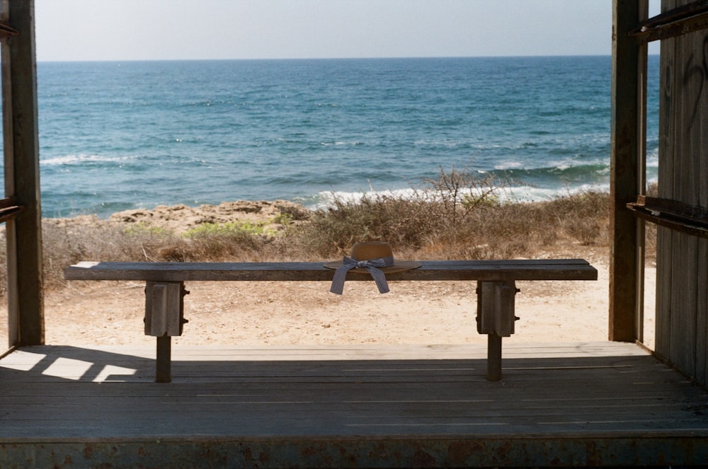 brown wooden picnic table on beach during daytime