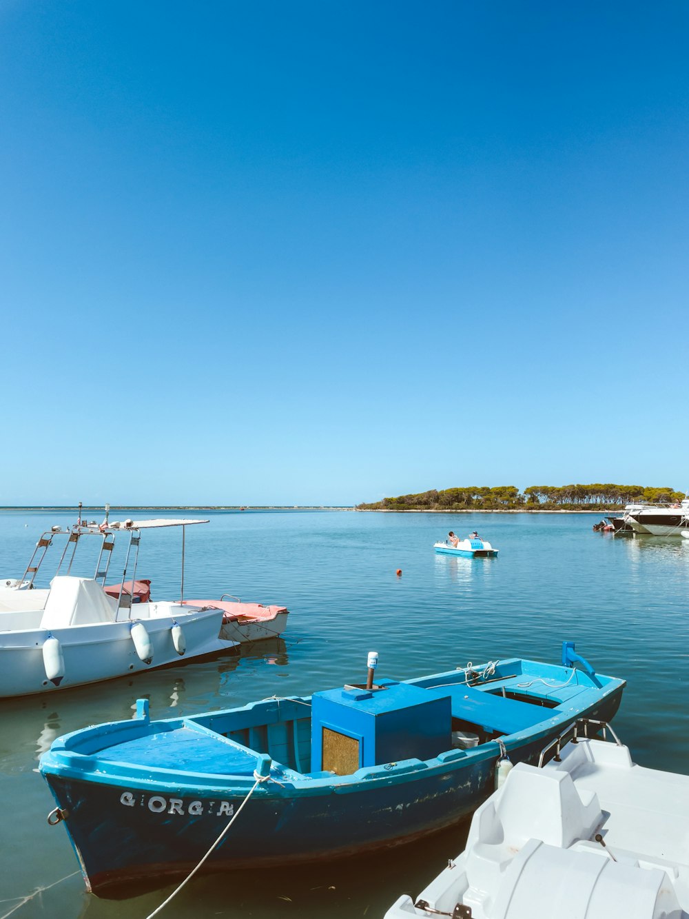 white and blue boat on sea during daytime