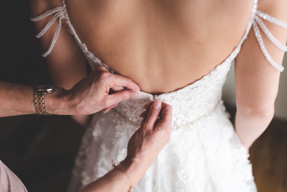 woman in white lace spaghetti strap top