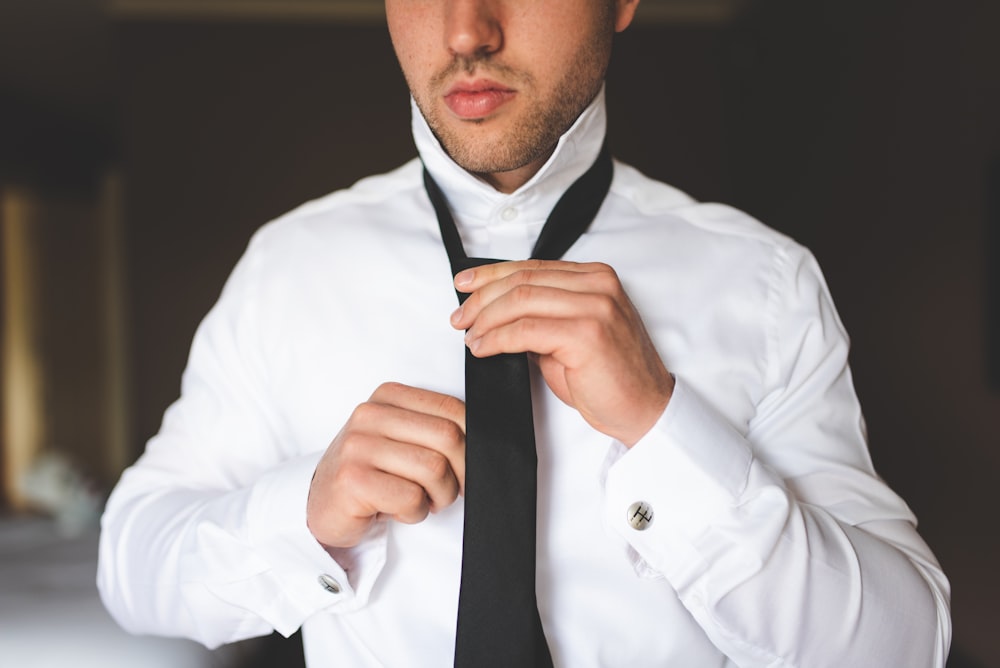 man in white dress shirt and black necktie