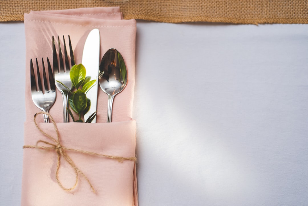 silver fork and bread knife on white tissue paper