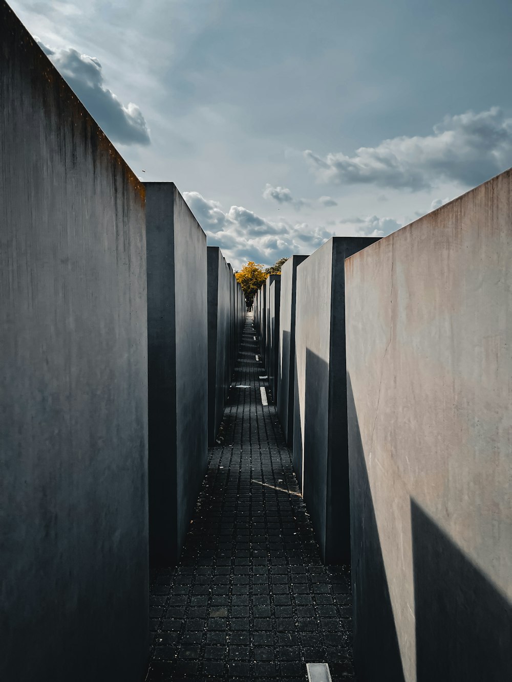 gray concrete wall under white clouds during daytime