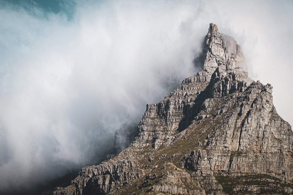 gray rocky mountain under white clouds during daytime