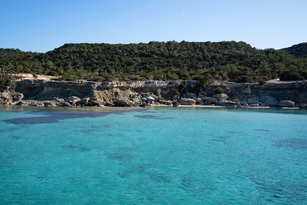 green and brown island on blue sea under blue sky during daytime