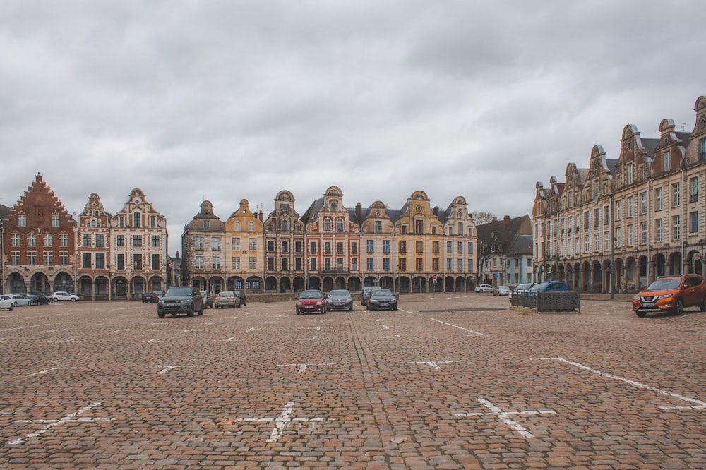 cars parked in front of brown concrete building during daytime