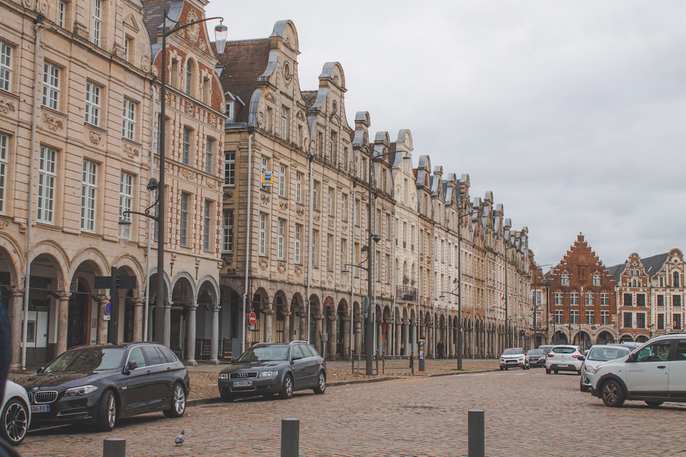 cars parked in front of brown concrete building during daytime