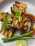 Close-up of golden-brown paneer tikka cubes made with moongcraft tofu, garnished with fresh herbs.