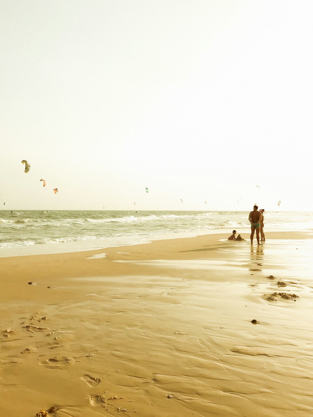 2 person walking on beach during daytime