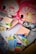 The image contains two children's backpacks with cartoon sheep designs, surrounded by various school supplies. The supplies include notebooks, scissors, a ruler, highlighters, an eraser, and colored markers. The backpacks have pink and red tones with decorative elements.
