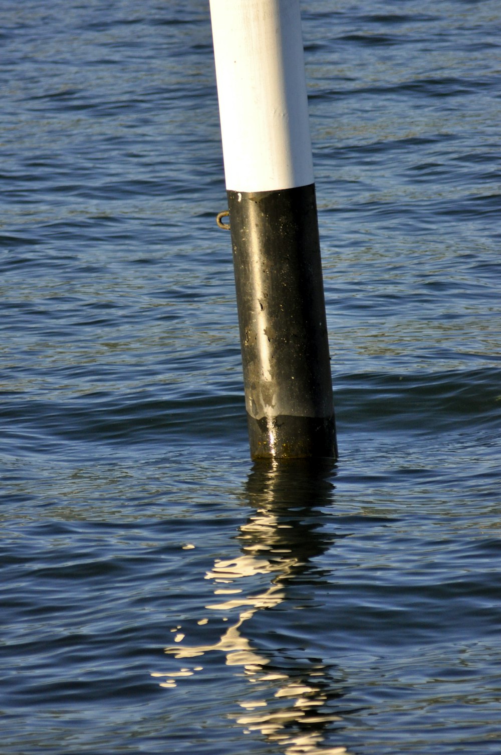 black and white metal rod on sea during daytime