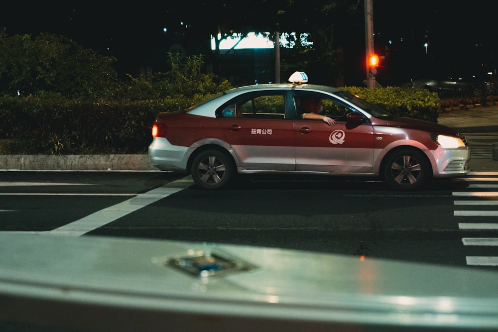 red sedan on road during night time
