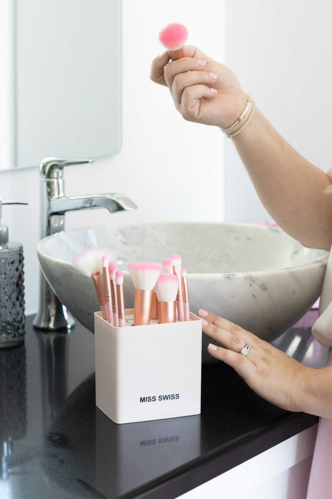 person holding white box near sink