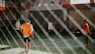 man in orange and white jersey shirt and black shorts standing on green and white tennis