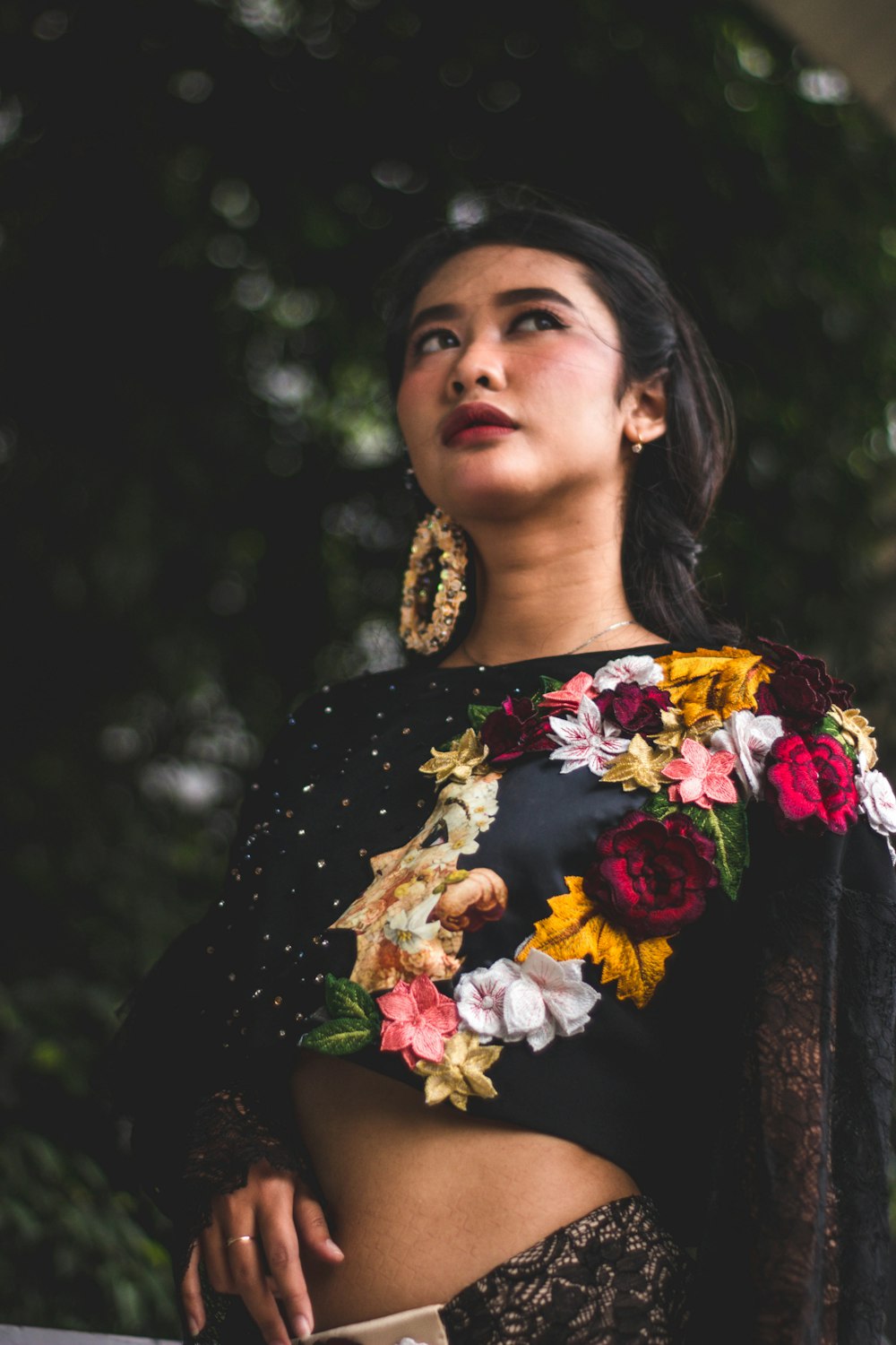 a woman in a black top with flowers on it