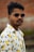 man in white yellow and blue floral button up shirt wearing black sunglasses