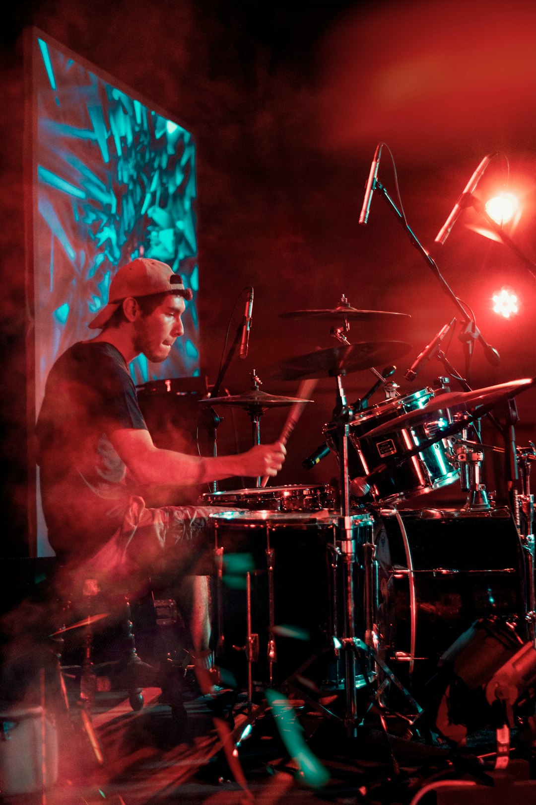 man in black shirt playing drum set