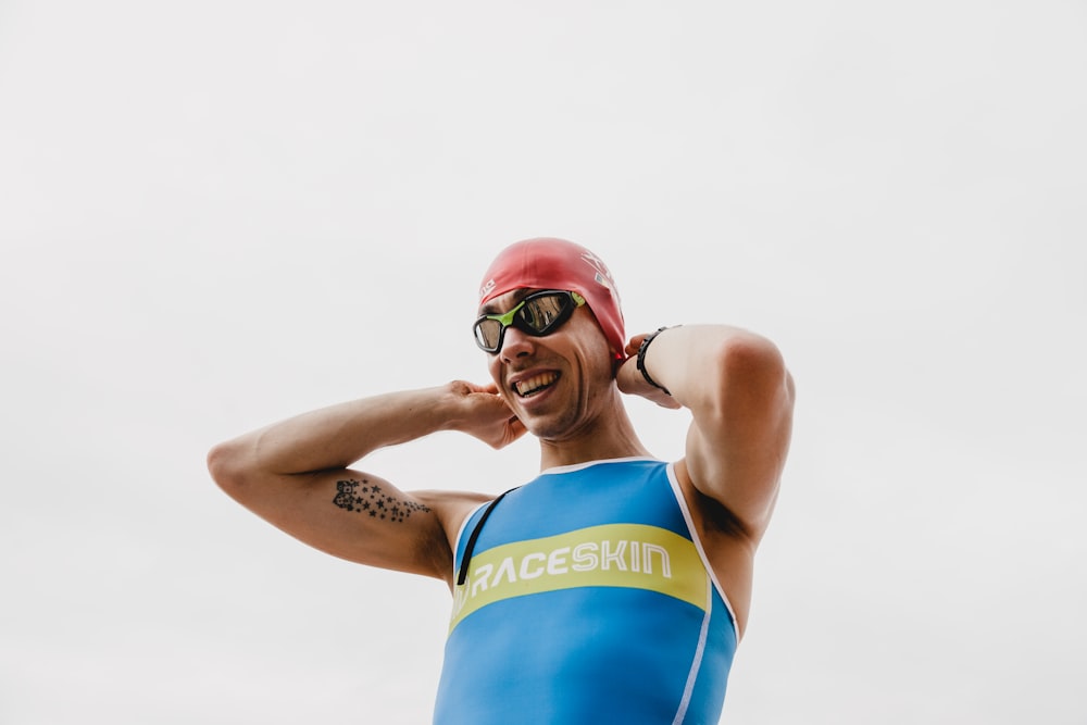 woman in blue and yellow tank top wearing red goggles