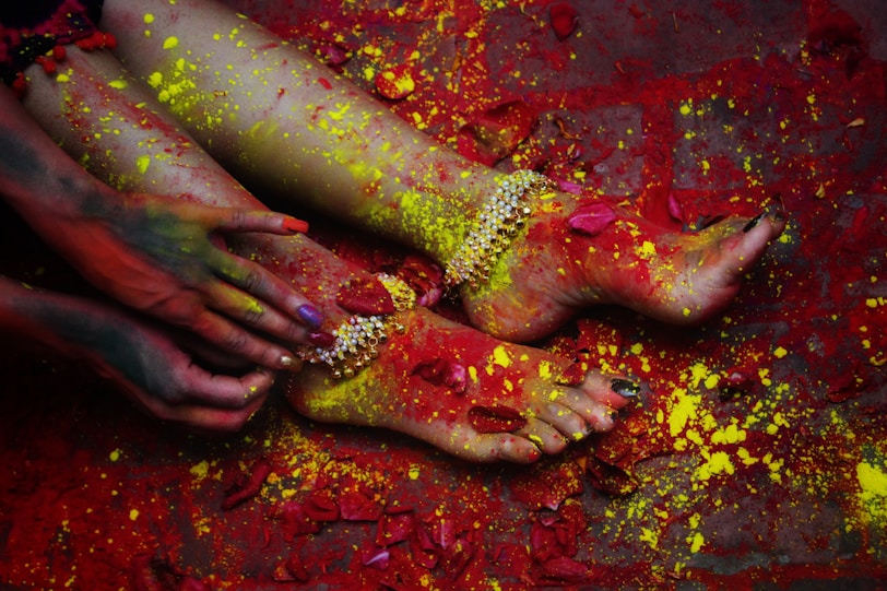 person with red and green paint on hand