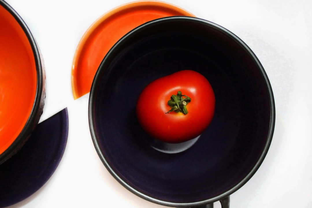 orange tomato on black ceramic plate