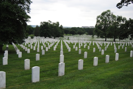 white cross on green grass field during daytime