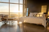 Bedroom with large windows, natural light, and stylish furnishings.