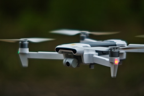 white quadcopter drone in close up photography