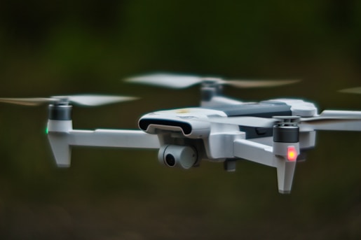 white quadcopter drone in close up photography