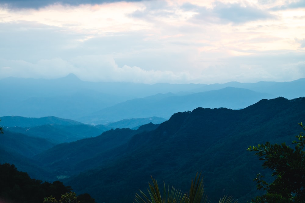 green mountains under white clouds during daytime