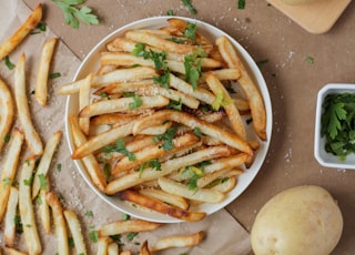 potato fries and sliced potato on white ceramic plate