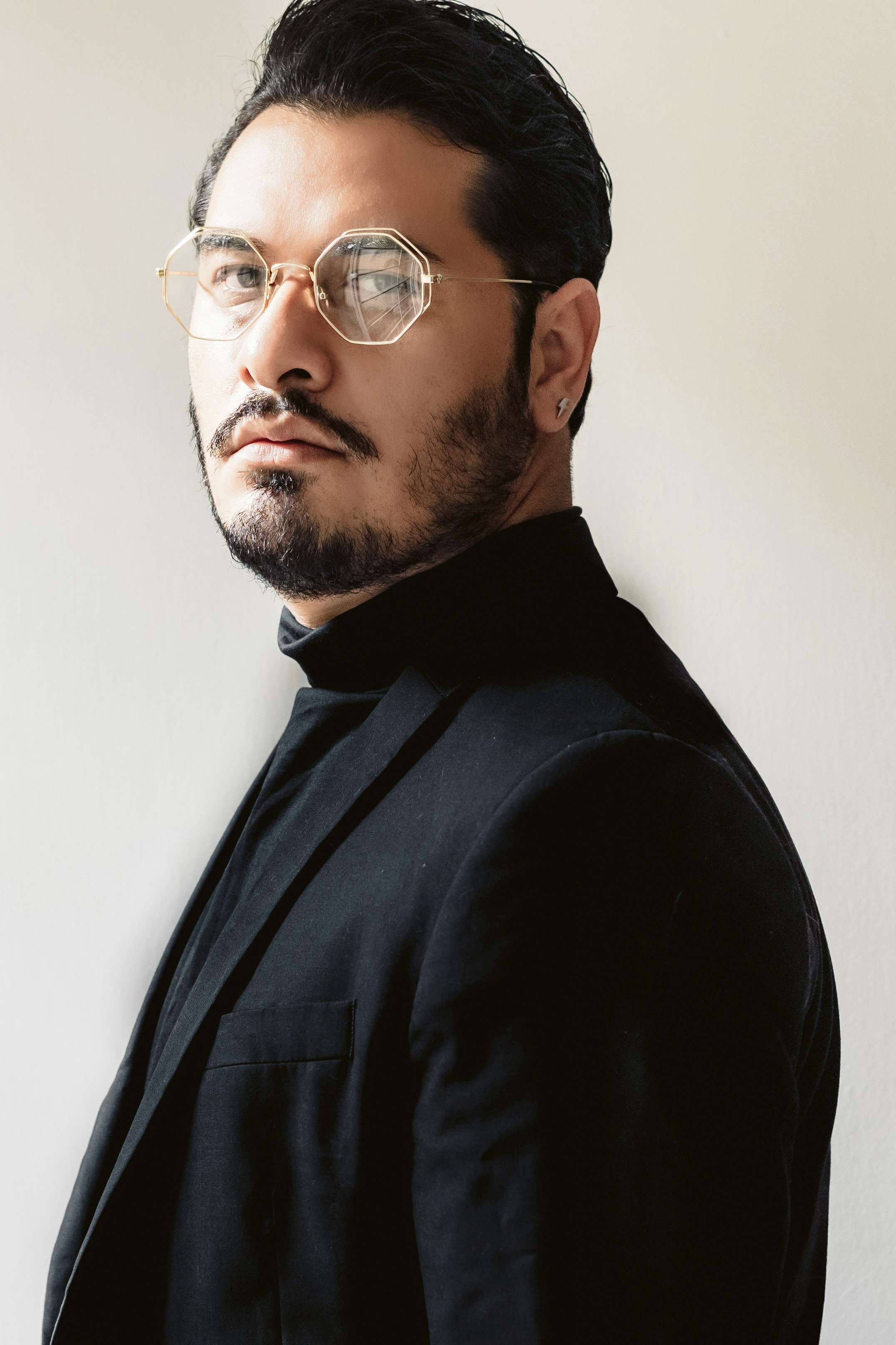 man in black suit wearing black framed eyeglasses