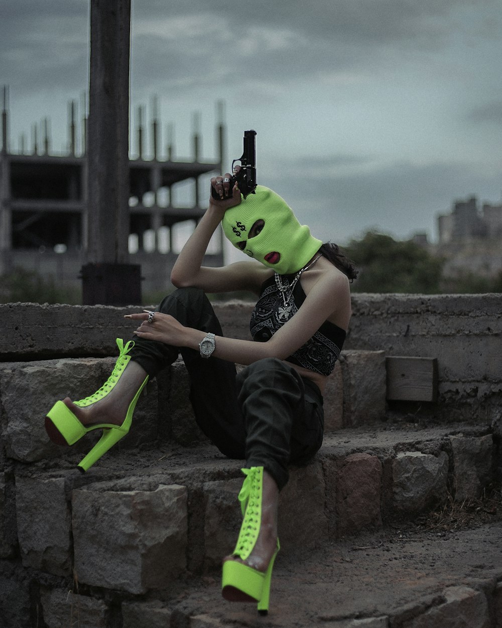 man in black t-shirt and black pants holding green and black plastic toy gun