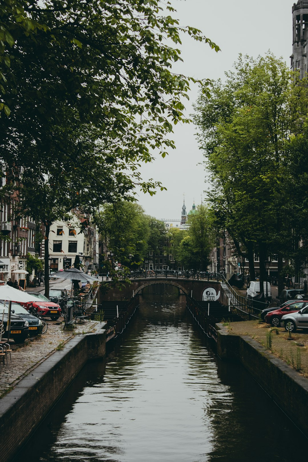 people walking on bridge over river during daytime