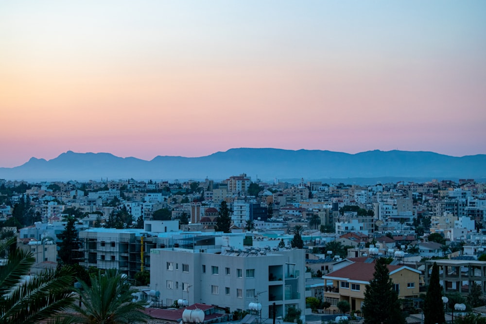 city with high rise buildings under orange sky