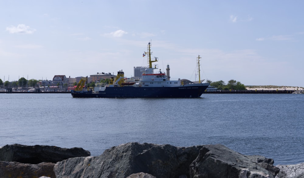 black ship on sea under white clouds during daytime