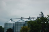 green trees near gray metal tower during daytime