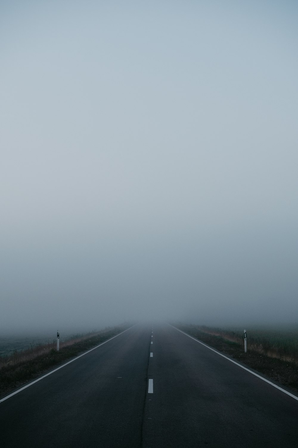 black asphalt road under gray sky