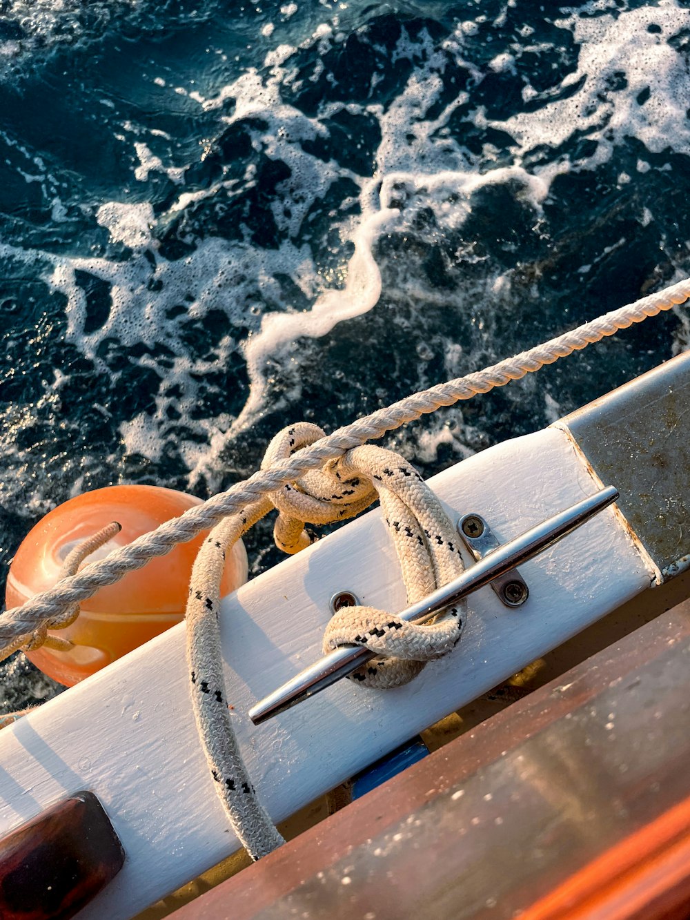 white and brown wooden boat with white rope