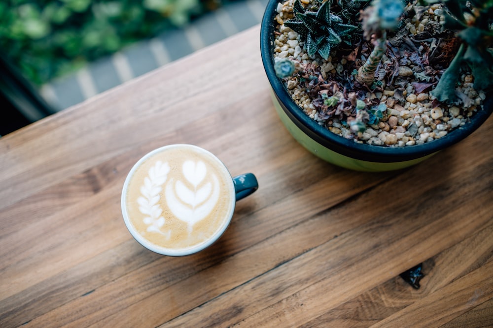 white and blue ceramic mug with coffee