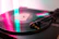A close-up of a vinyl record spinning on a turntable with colorful sound waves radiating around it.