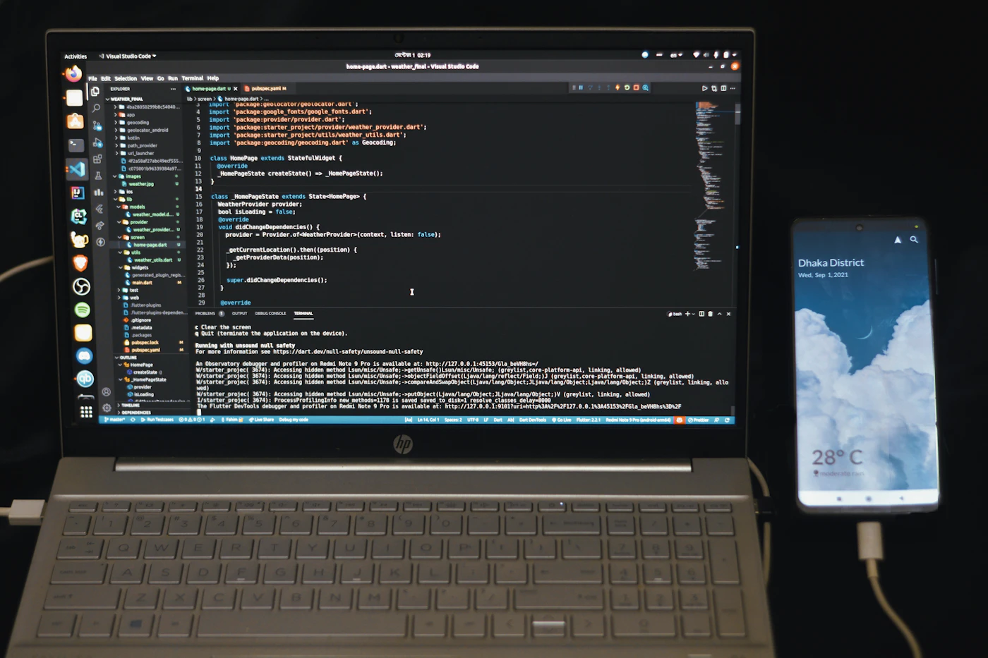Laptop showing mobile app development code beside a smartphone, representing React Native and Flutter framework comparison.