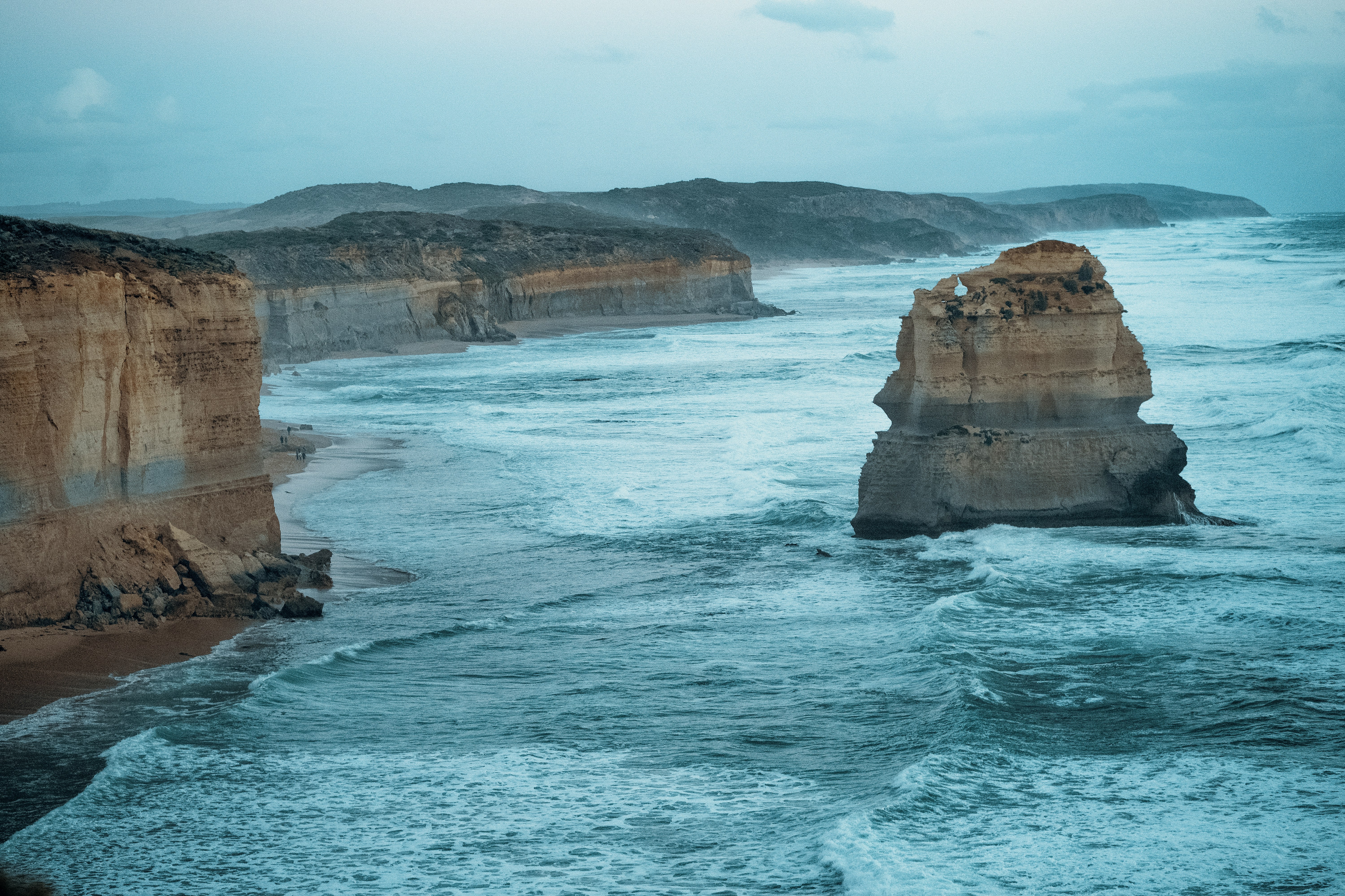brown rock formation on sea during daytime