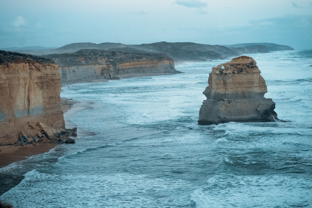 brown rock formation on sea during daytime