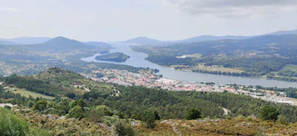Panoramic shot of São José da Barra’s scenic landscape with mountains and river.