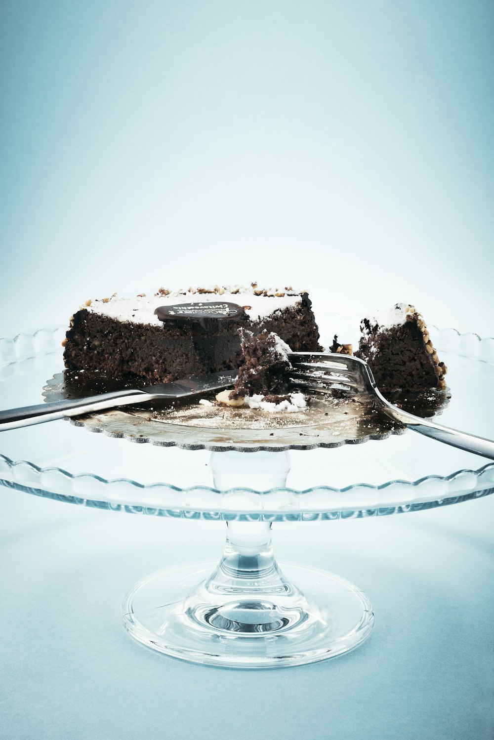chocolate cake on clear glass cake stand
