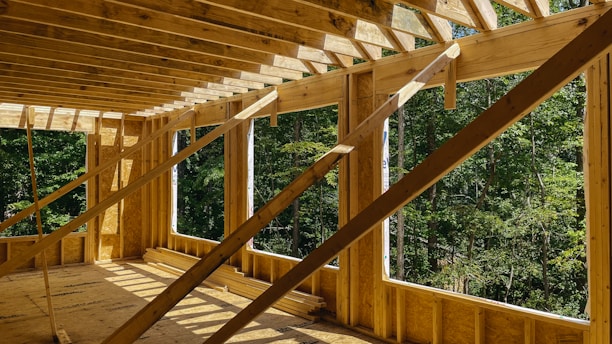 brown wooden staircase near green trees during daytime