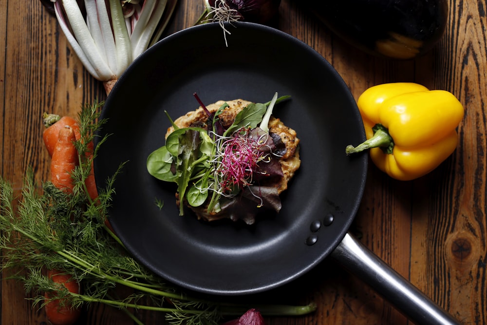 vegetable salad on black plate