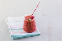 red liquid in clear drinking glass