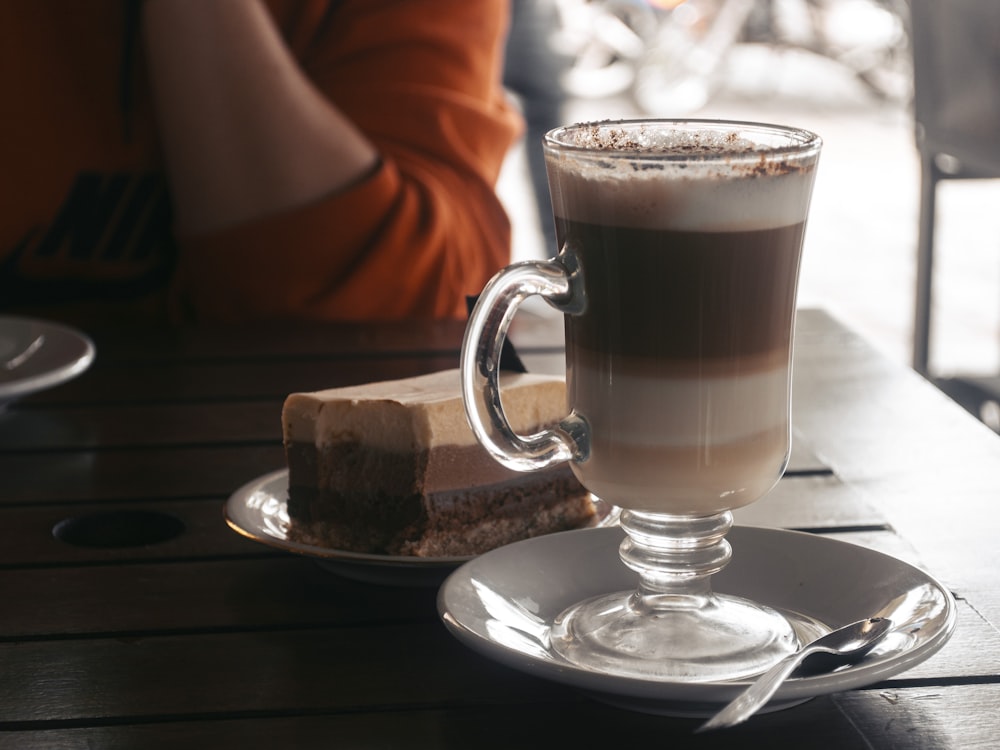 clear glass mug on white ceramic plate