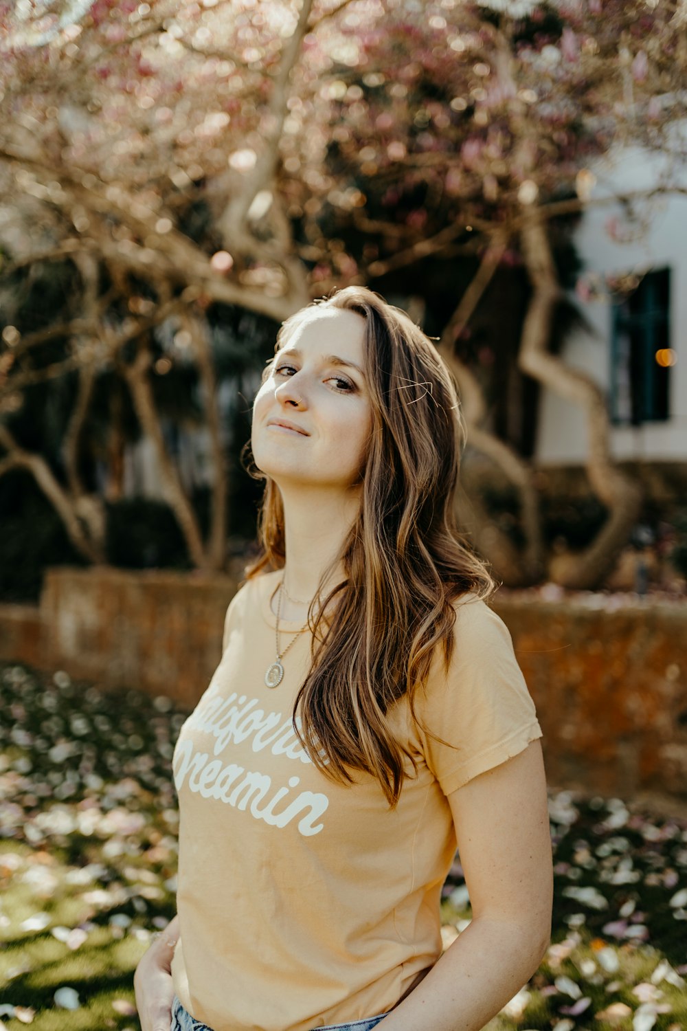 woman in yellow crew neck t-shirt standing on brown and white concrete floor during daytime