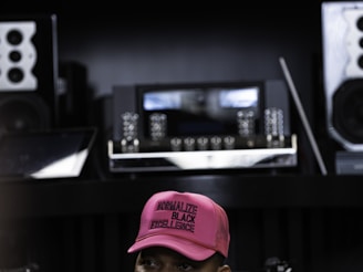 man in red fitted cap and red baseball cap